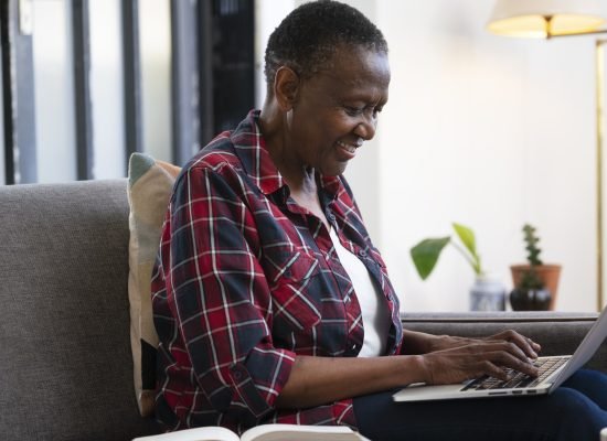 side-view-smiley-woman-with-laptop-indoors